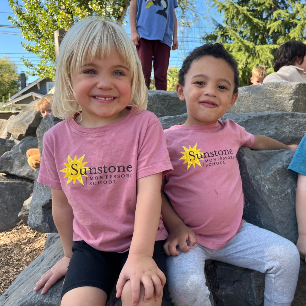 two thriving, joyful, and self-assured children greet the camera with confidence