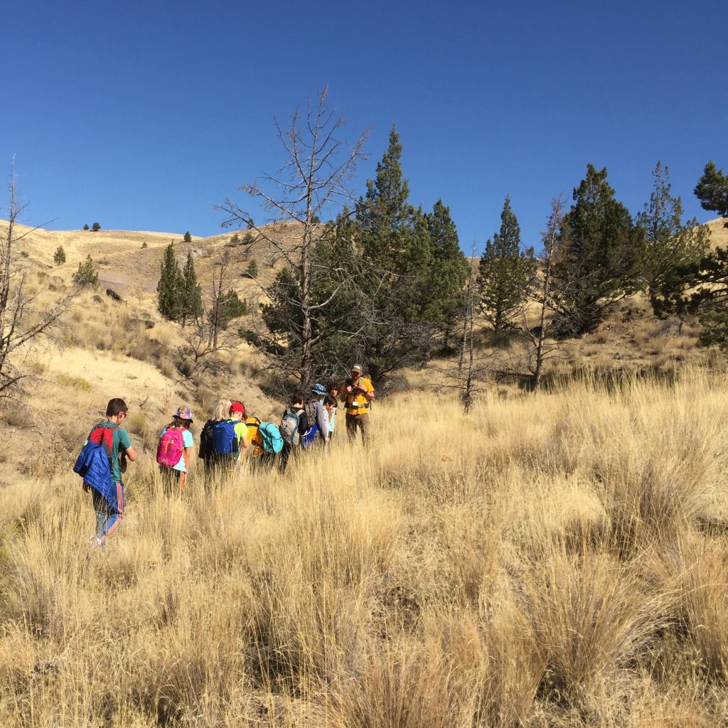 Students find fossils on a hike in eastern Oregon as part of science camp